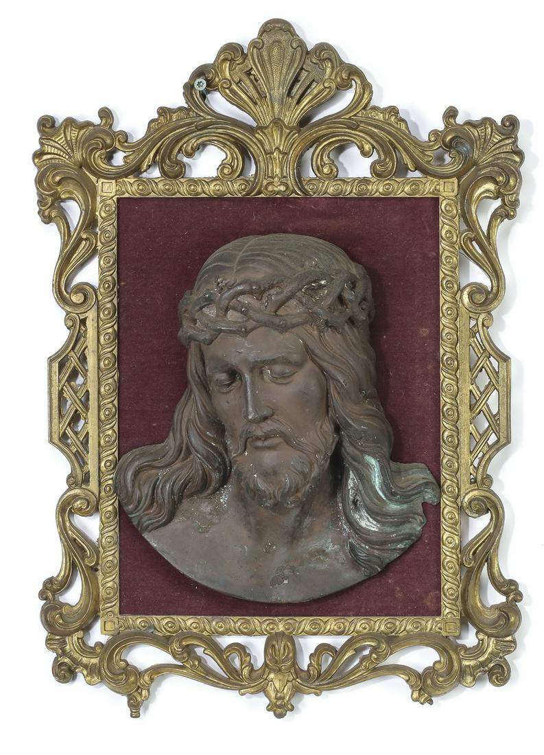 Continental bronze relief plaque of Christ: Continental bronze plaque depicting the head of Christ in relief, the figure wearing a crown of thorns with his gaze cast downward, mounted to a red velvet lined gilt metal frame in the Rococo taste, 