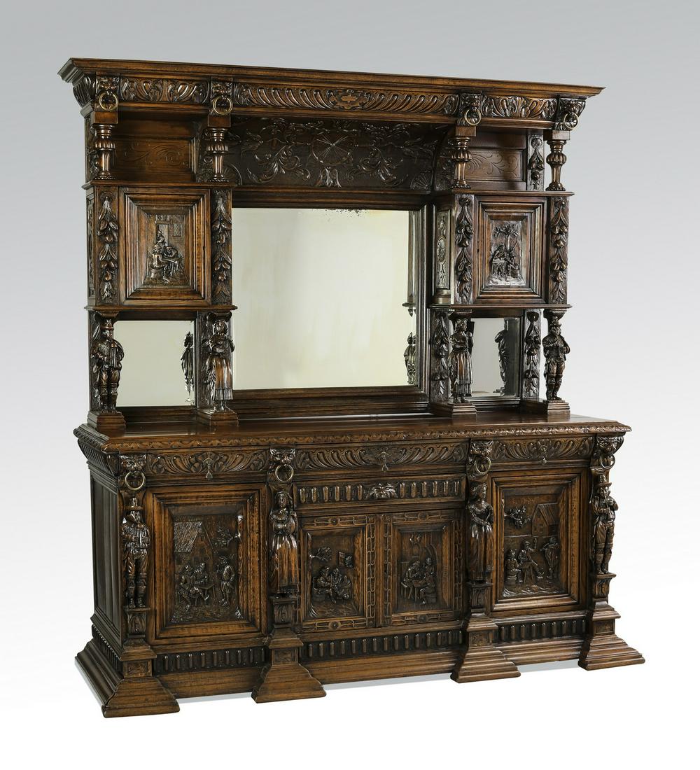 Early 19th c. Jacobean style carved oak buffet: Early 19th century Jacobean style oak two part buffet, having a molded cornice accented with lion masks and rings, above a pair of open shelves with turned stiles centering a relif carved panel of aca