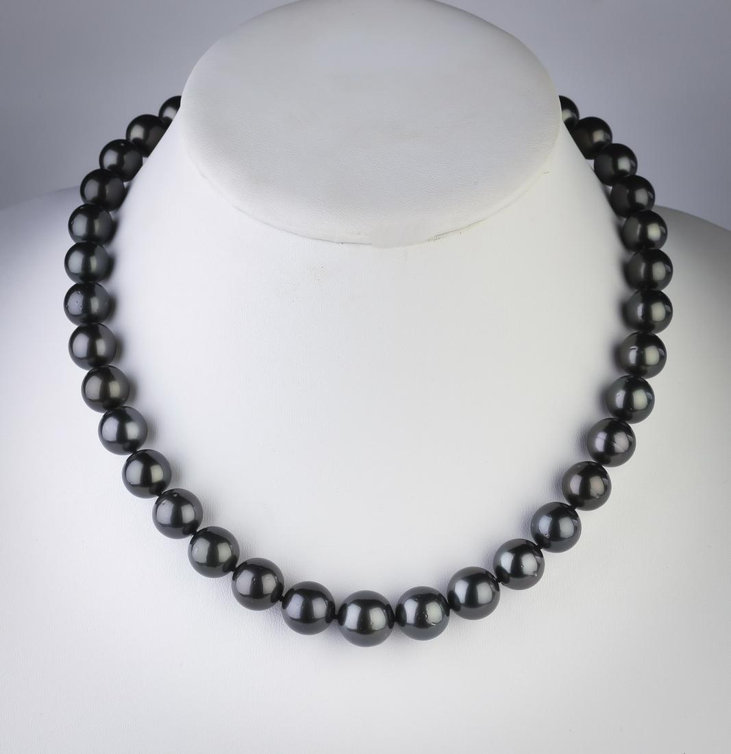 Tahitian pearl, diamond, and 14k necklace, 18"l: Tahitian pearl, diamond, and 14k white gold necklace, having 37 dark grey pearls of 10-13mm, finished with a white gold ribbed ball clasp, marked 585, with an AIGL report, 18"l. **Please note that all