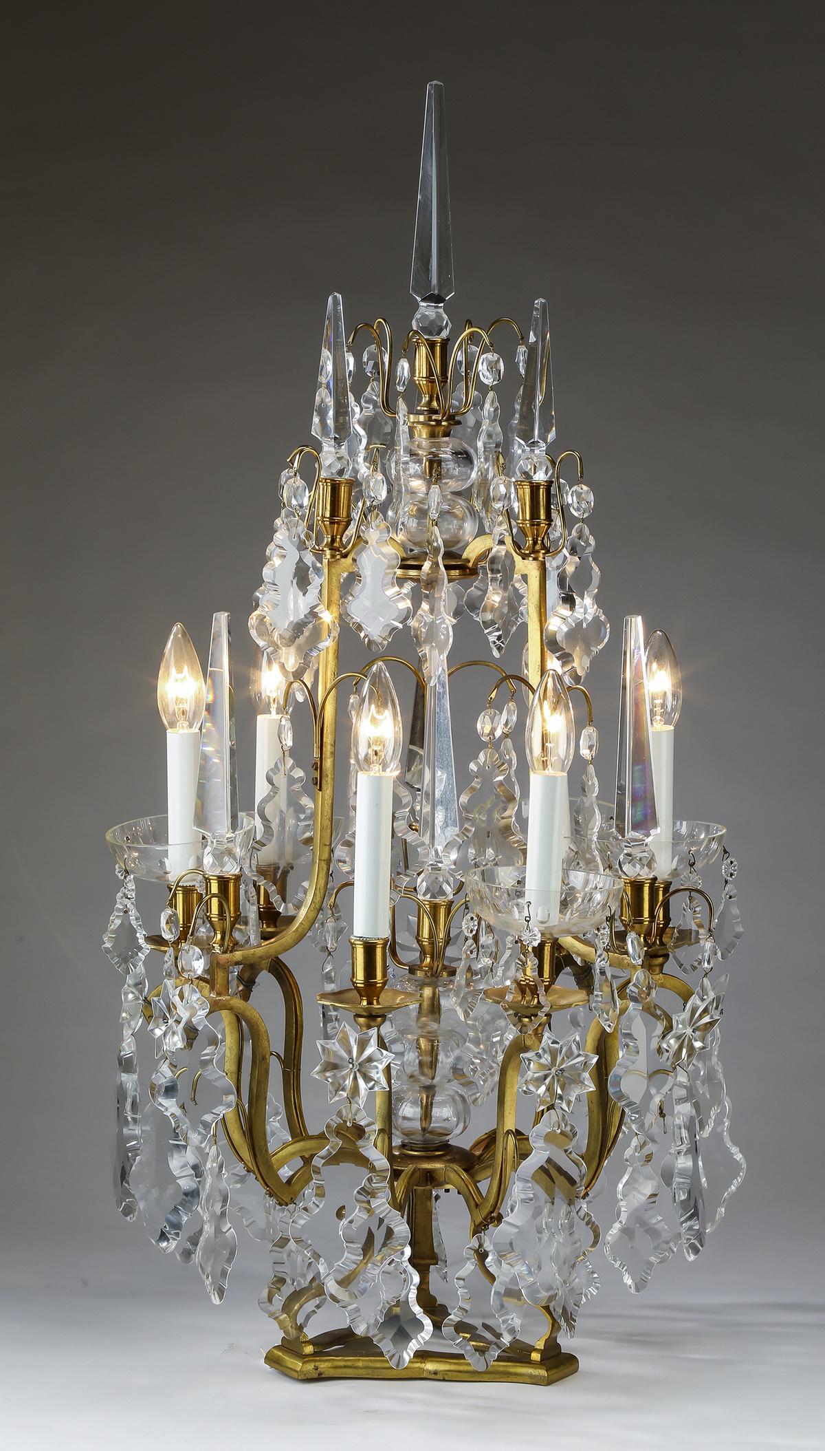 Gilt bronze 6-light girandole with crystal obelisks: Continental crystal and gilt bronze 6-light girandole in the Louis XV taste, having a three sided crystal obelisk finial over a cage composed of three pairs of lights interspaced with crystal obelisks