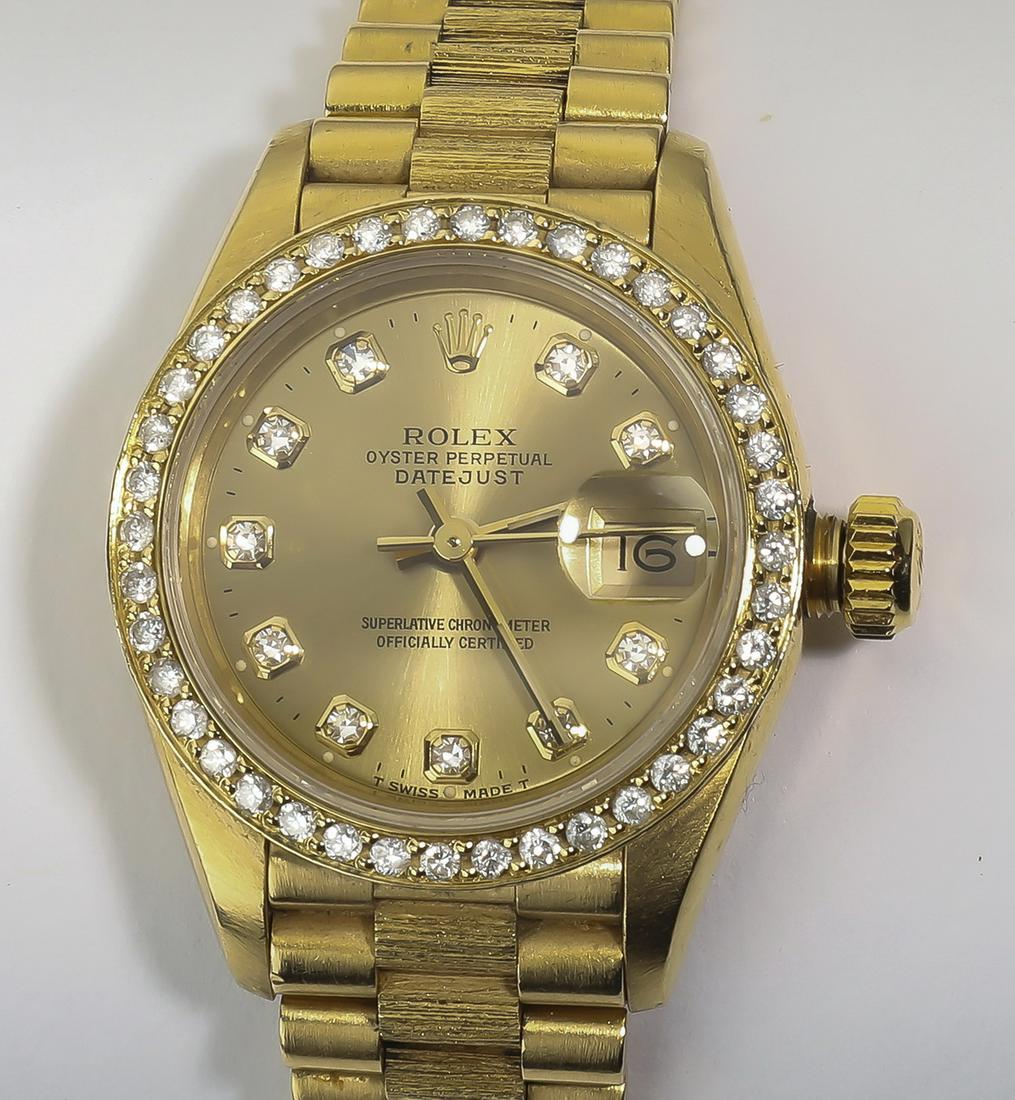 Lady's 18k yellow gold and diamond Rolex President: Lady's 18k yellow gold and diamond Rolex President Datejust, having a 29mm case with an original Rolex champagne dial, having diamond markers and an after market diamond bezel, on a Rolex 18k Presiden