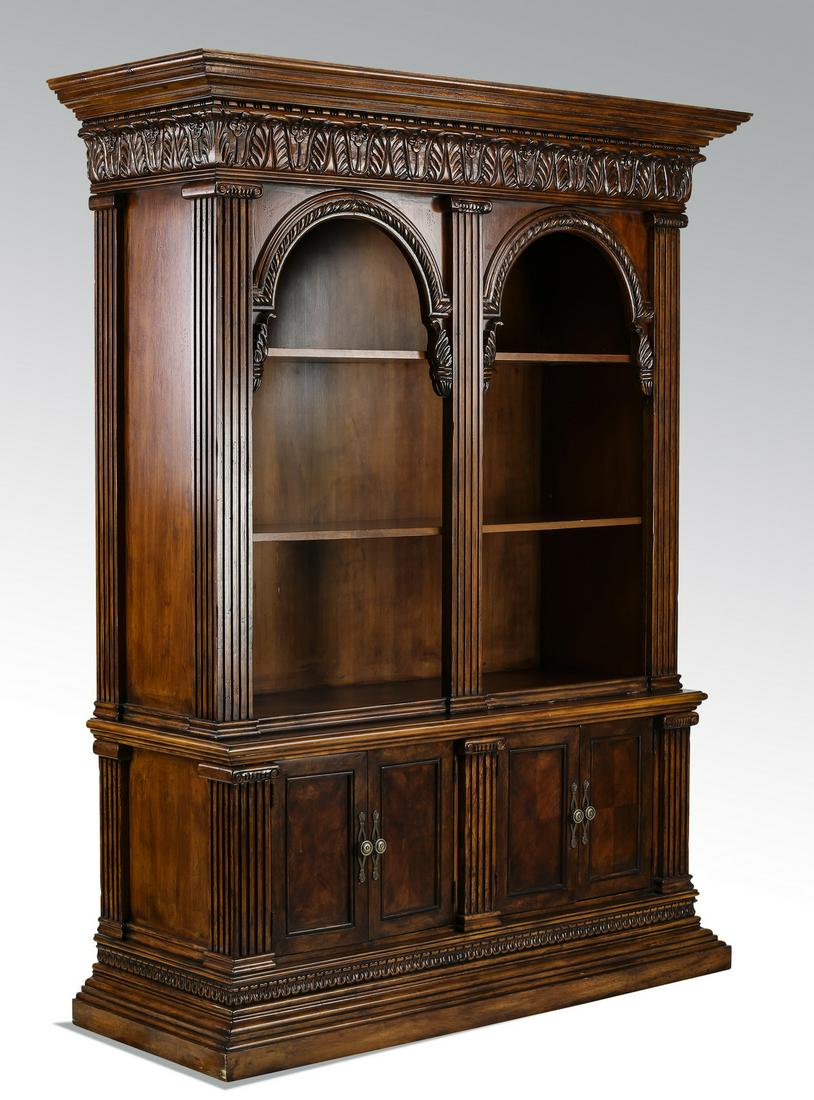Classical style library bookcase, 85"h: Carved bookcase in the classical Roman taste, the upper case having a molded cornice ornamented with bead and reel over a frieze of carved flowers, above a double arched bookcase flanked by fluted Ion