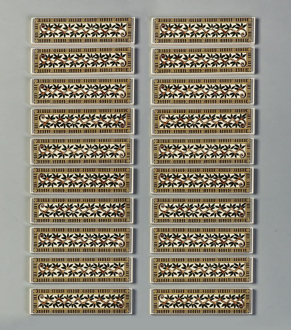 (20) Naturalistic motif decorative ceramic tiles, 6"w: Group of (20) decorative ceramic tiles, each having a geometric border framing a central vine motif, each tile measuring 1.5"h x 6"w.