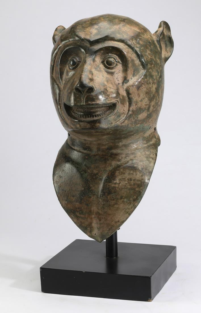Chinese patinated cast iron bust of a monkey: Chinese patinated cast iron bust of a monkey, resting on a custom stand, 22"h x 12"sq. Provenance: From the Private Collection of a distinguished Southern gentleman.