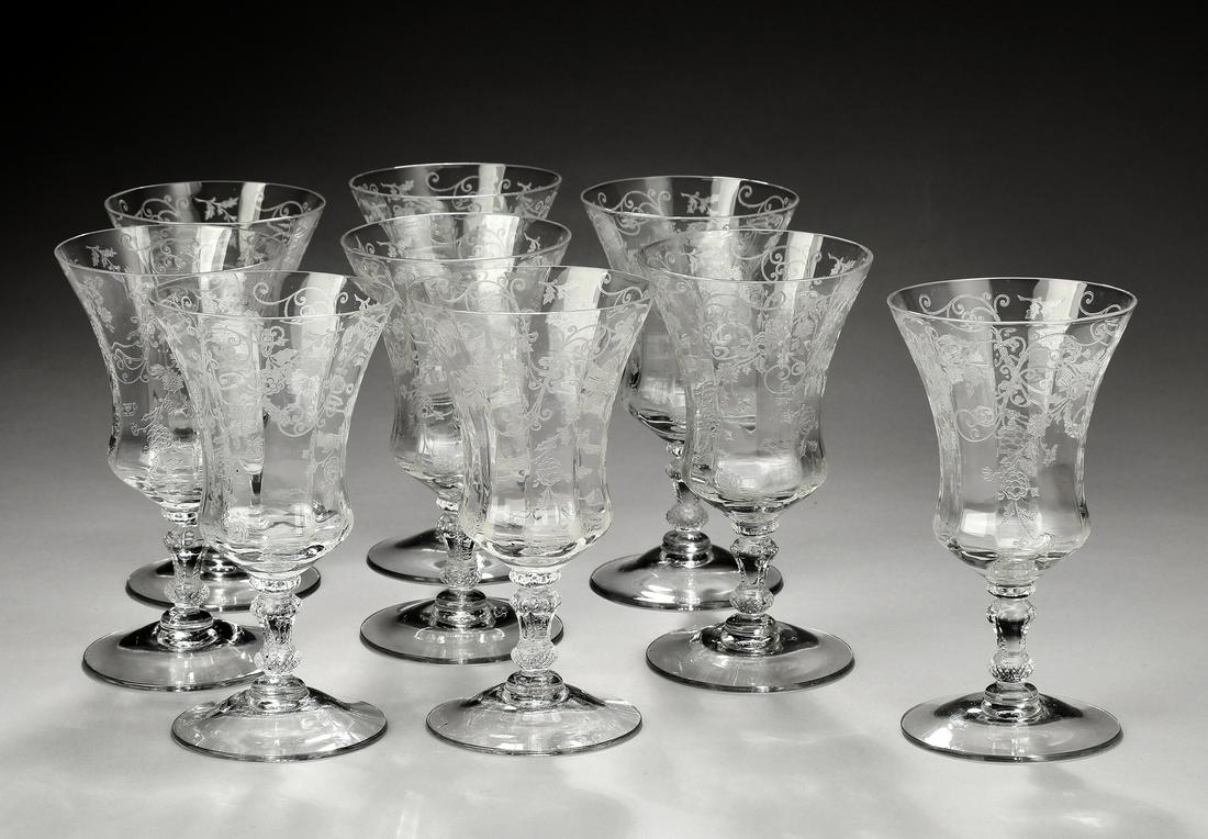 Group of (9) Fostoria etched glass wine glasses: Group of (9) Fostoria etched glass wine glasses, of flared form, having all-over foliate garland etchings, rising on a stylized standard, 5.25"h x 2.75"dia.