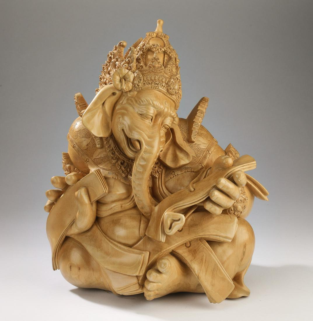 Signed Balinese sculpture of Lord Ganesha, 18"h: Signed Balinese hand carved sandal wood sculpture of Lord Ganesha, the Hindu deity of knowledge and intellect is depicted seated, delighting in the sutras or scriptures he holds in his hands, having a