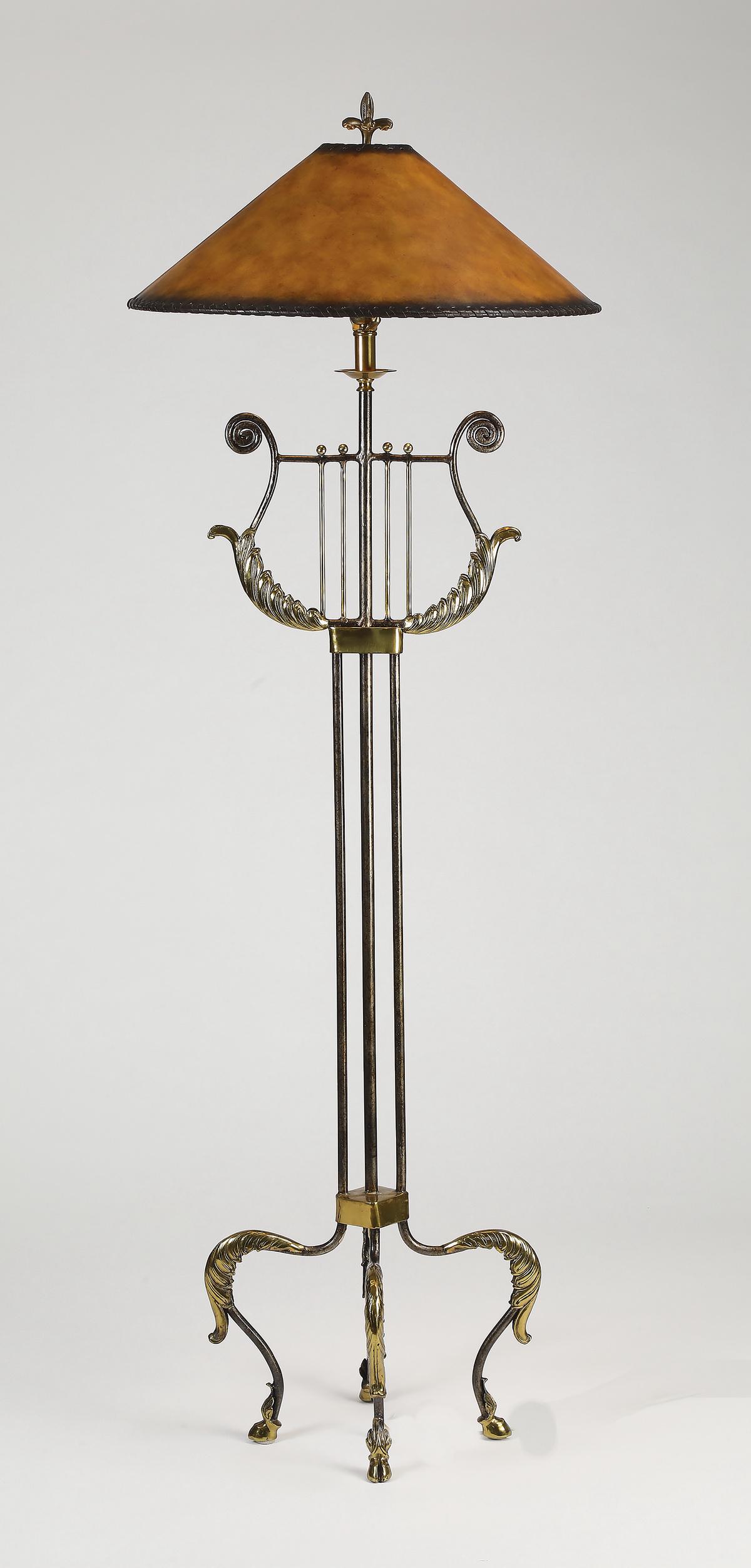 Neoclassical style brass and metal floor lamp, 66"h: Brass and metal floor lamp in the Neoclassical taste, having a coolie shaped faux leather parchment shade above a harp, over a tubular column, the whole rising on four cabriole legs terminating to hoo