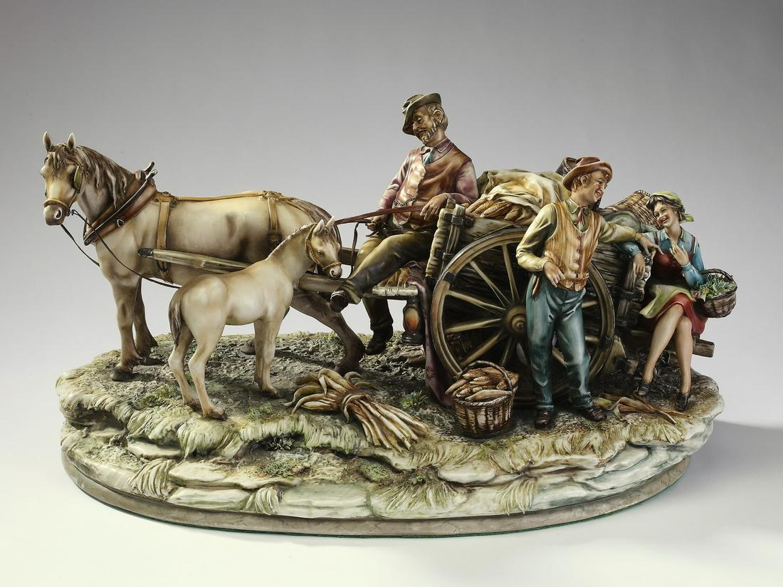 Antonio Borsato porcelain grouping, 'Harvest Flirt': Large Antonio Borsato Italian porcelain figural grouping, 'Harvest Flirt' depicting a driver waiting patiently atop a horse drawn wagon of harvested corn, while a young man chats with a girl sitting o