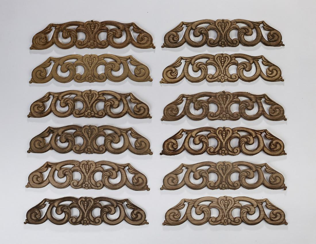 (12) Continental carved decorative appliques, 9"w: Group of (12) Continental carved decorative appliques, in a pierced scrollwork design, ready for your own stained or painted finish, 2"h x 9"w.