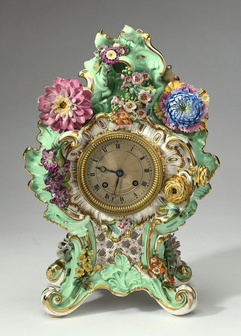 19th c. French Rococo Revival porcelain bracket clock: French Rococo Revival porcelain bracket clock in the style of Meissen, late 19th or early 20th century, the waisted case having pale green foliate 'C' scrolls and festooned with bright flowers, center