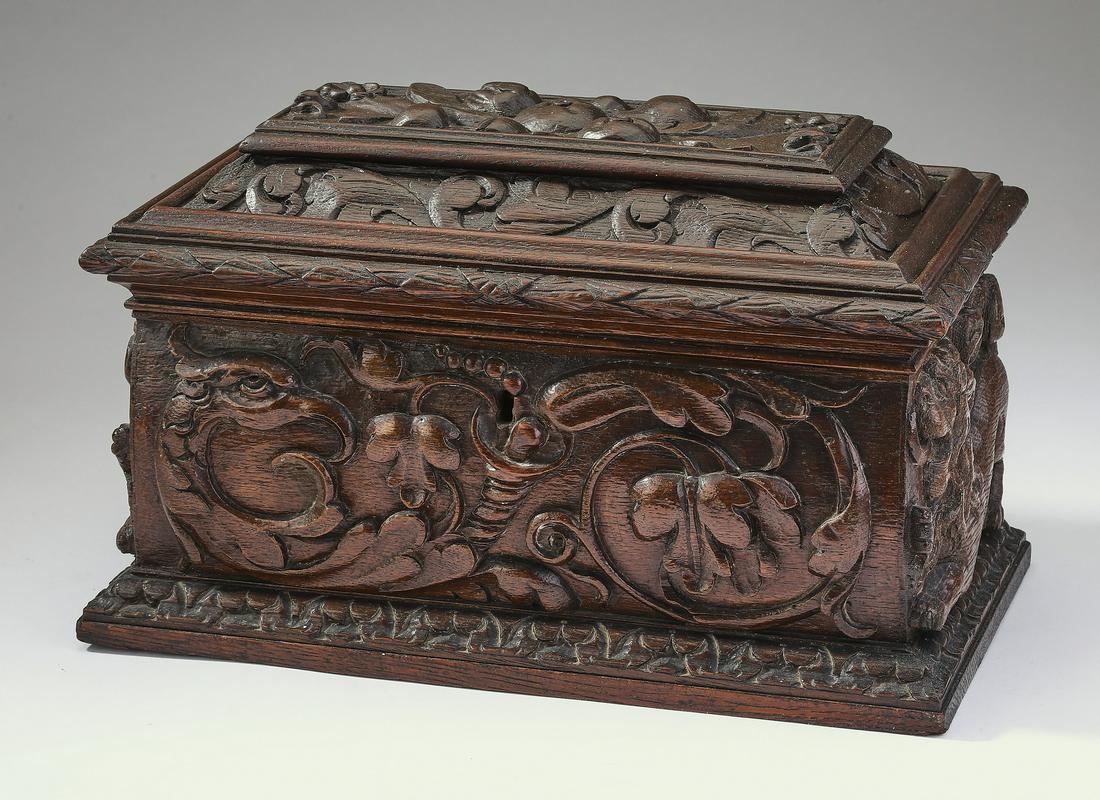 Large 19th c. English carved oak tea caddy, 13"w: English Renaissance Revival carved oak tea caddy, late 19th century, of coffered rectangular form, with a hinged lid opening to a fitted interior, having a crystal mixing bowl flanked by two removable