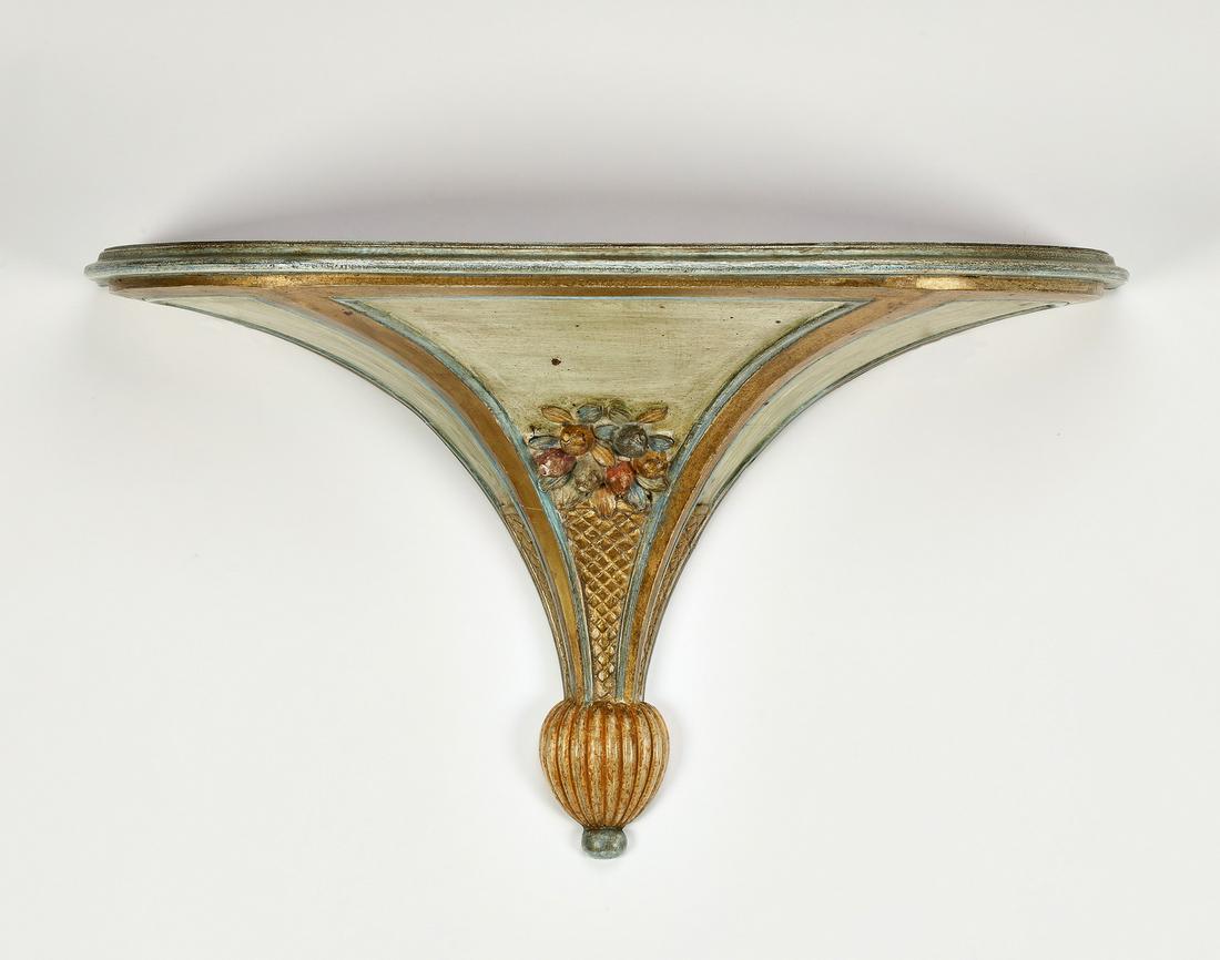 Italian gilt and paint decorated bracket: Italian gilt and paint-decorated architectural bracket, in the Rococo taste, having a shelf rising on a tapering standard painted with fruit and florals, terminating in a fluted spherical finial, 16"h
