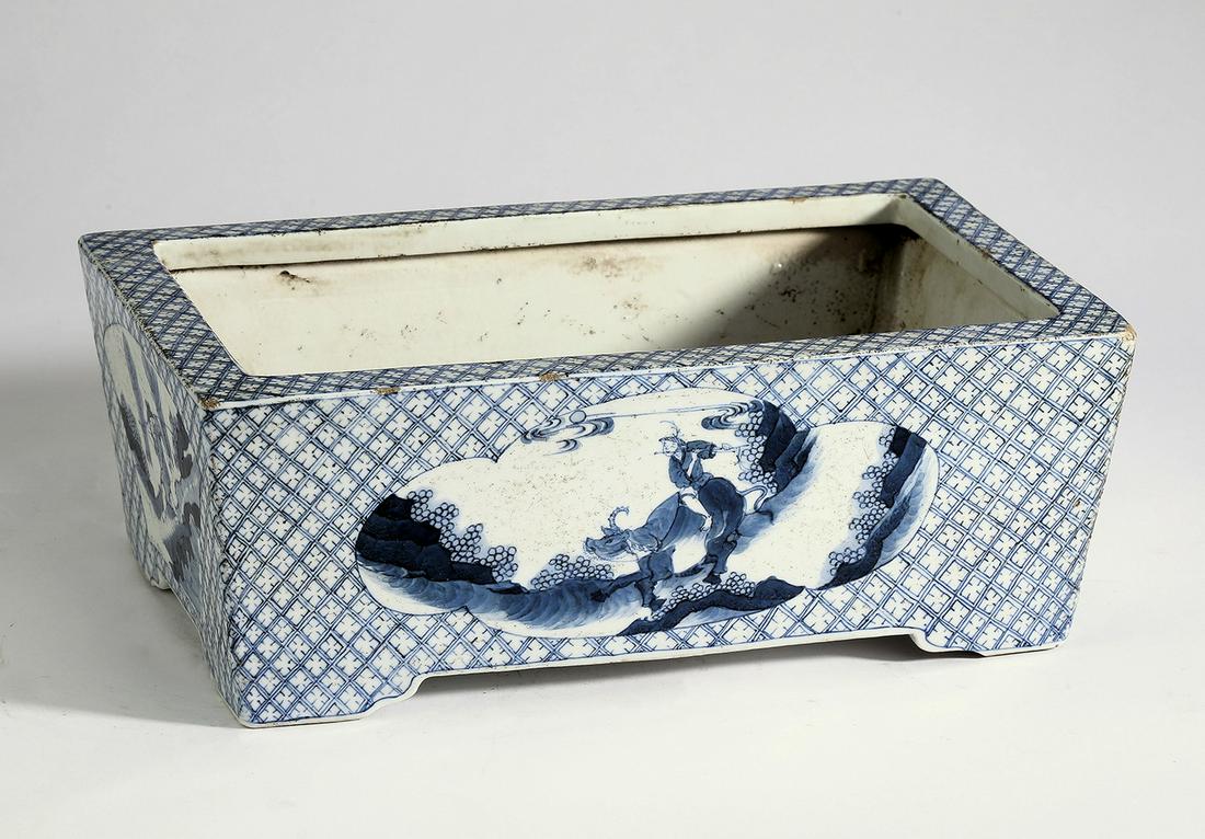 Chinese planter with Lao Zi and a scholar: Chinese blue and white planter, of rectangular form, having a flattened rim, decorated with a scene of a scholar enjoying leisure pursuits in a bucolic setting on one side, and Lao Zi astride his ox o
