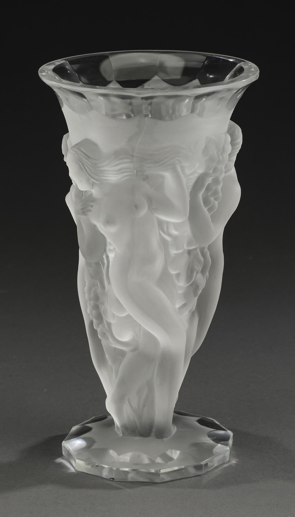 Dancing nymphs vase in frosted crystal, signed: Dancing nymphs vase executed in frosted crystal of trumpet form, having three frosted nymphs dancing around clusters of grapes surmounting a circular foot, signed on the bottom 'Desna,' 8.5"h x 4.5"d.