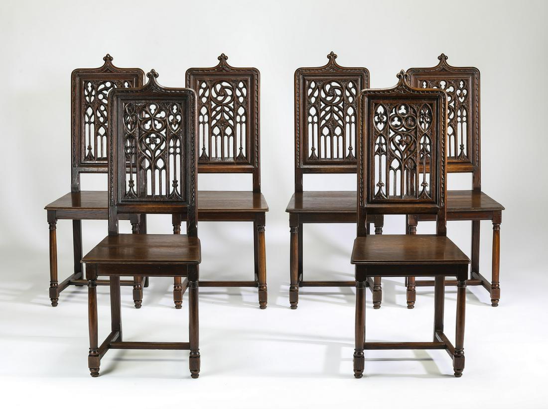 (6) 19th c. French Gothic Revival walnut chairs: (6) French Gothic Revival walnut side chairs, late 19th century, centering a fleur de lis finial over rectangular backs, decorated with pierced tracery in four patterns, fitted with square seats, the 