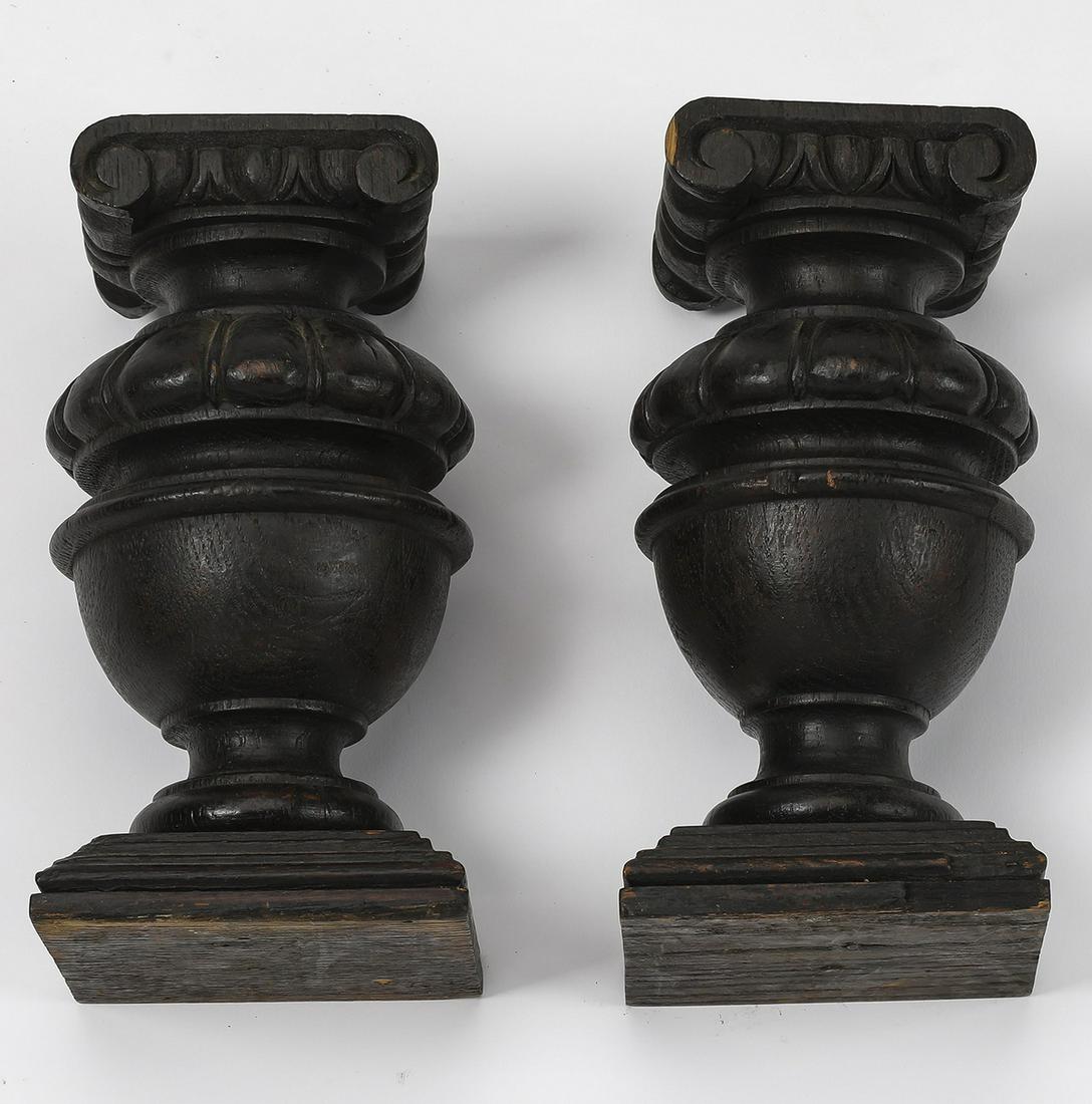(2) Continental carved architectural elements: Pair of turned and antiqued architectural elements, each having Corinthian capitals surmounting the turned cup and cover standard, terminating in a plinth base, 8"h x 4"w x 4"d.