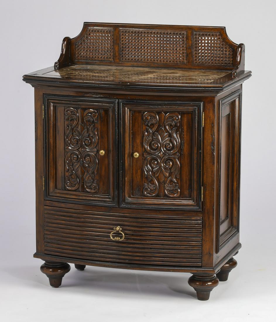 Marge Carson marble top bowfront nightstand: Marge Carson nightstand in the Neoclassical taste, having a bowfront case with inset marble top and caned backsplash, fitted with two carved doors over a reeded drawer, the whole rising on toupie feet