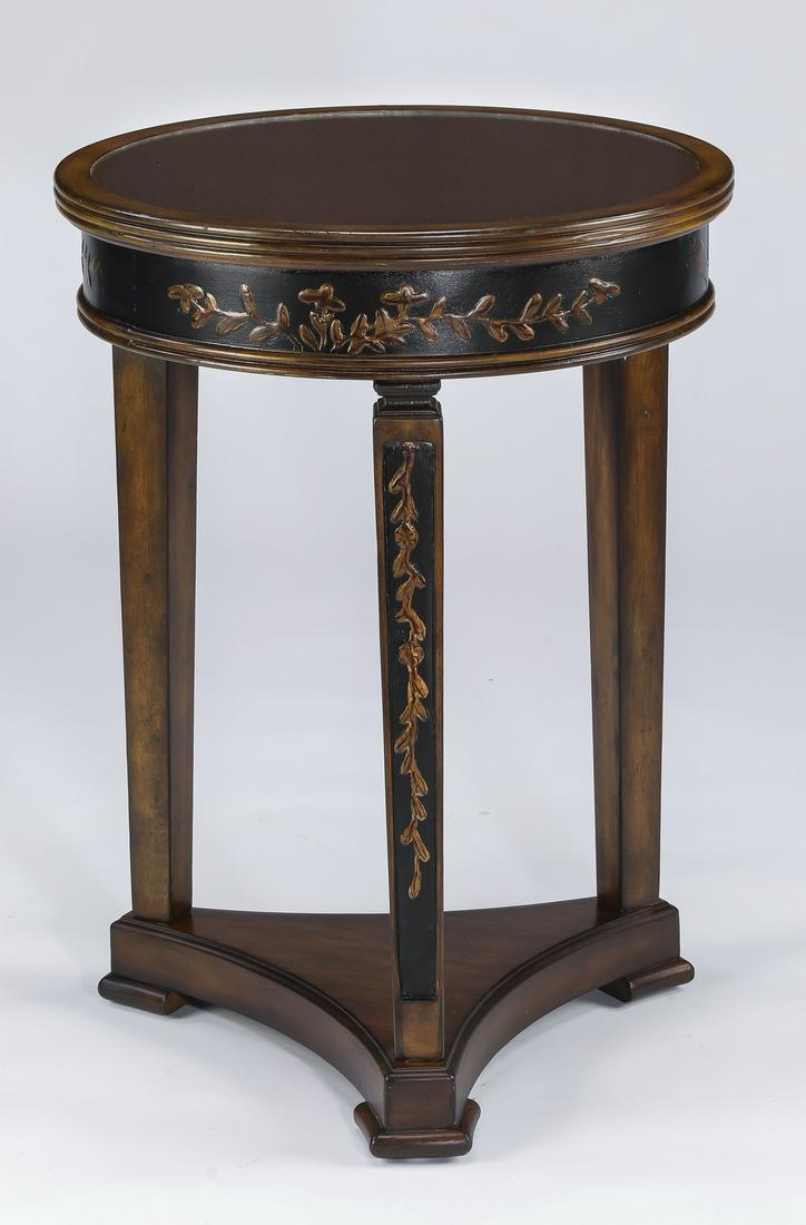 Regency style mirror topped occasional table, 20"dia.: Regency style mahogany and mirror topped occasional table, having a circular top with inset antiqued mirror, over squared and tapering legs, decorated throughout with an ebonized ground and parcel gil
