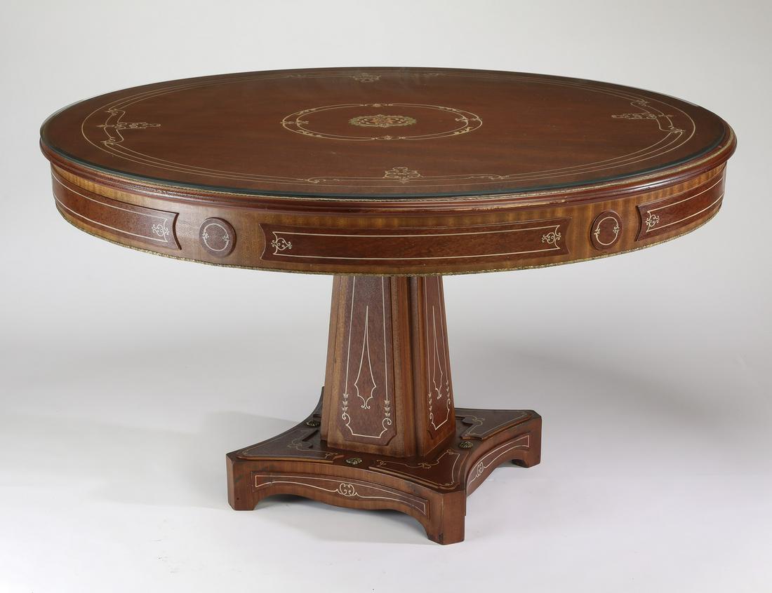 Continental style burl table with leather accents: Continental style circular burl and leather accented table with protective glass topper, having a circular leather top with a central polychrome rosette encompassed in scrolling bands, surmounting a w