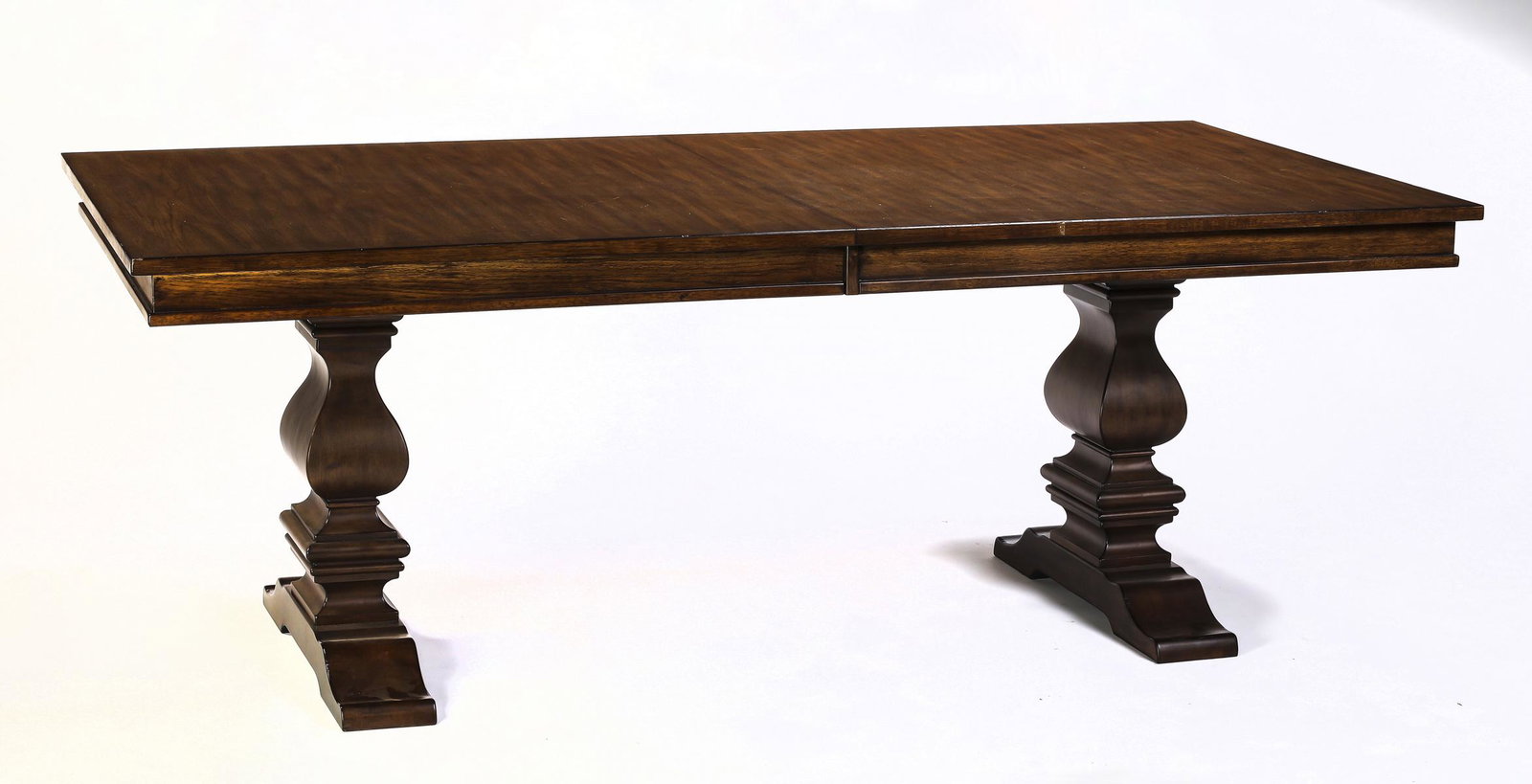 Old World style rustic farm table, 82"l: Old World style rustic farm table, having a rectangular birch veneer top, rising on two squared baluster pedestals terminating to shoe feet, 30"h x 42"w x 82"l.