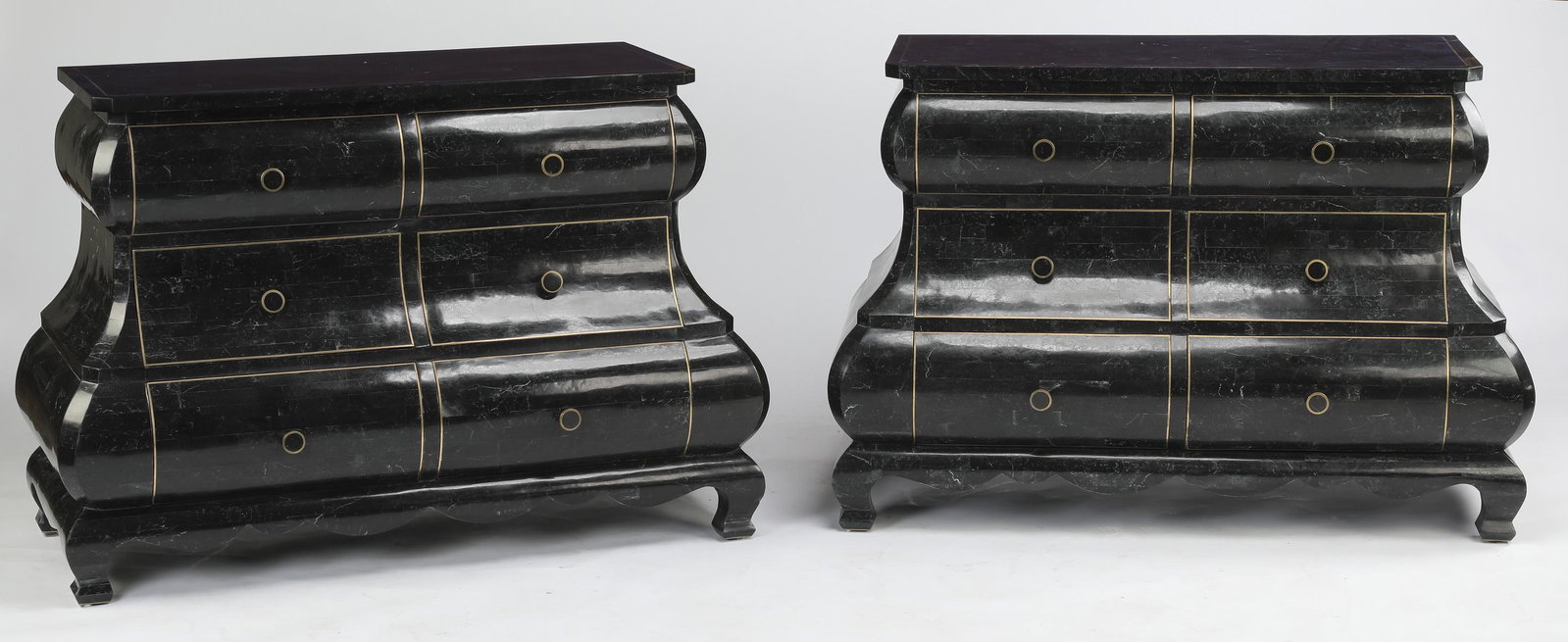 (2) Dark gray tessellated marble commodes: Pair of Hollywood Regency style dark gray tessellated marble bombe' commodes, each having a rectangular top, above three rows of two drawers, each accented with brass exterior banding, surmounting a s