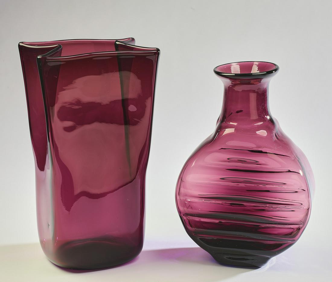 (2) Mid 20th century amethyst art glass articles: Two amethyst art glass vases, mid 20th century, comprising: (1) 'paper bag' form vase, 11.25"h x 6.5"w x 5"d; and (1) vase of moon flask form having a flared rim and horizontal indentations on the bod