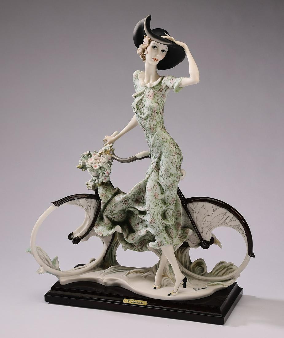 Giuseppe Armani art sculpture, 'Lady with a Bicycle': Giuseppe Armani art sculpture, 'Lady with a Bicycle - Spring,' 1989, depicting a young lady in a moss green printed dress next to a bicycle with a basket full of flowers, maker marked and signed, 15.5