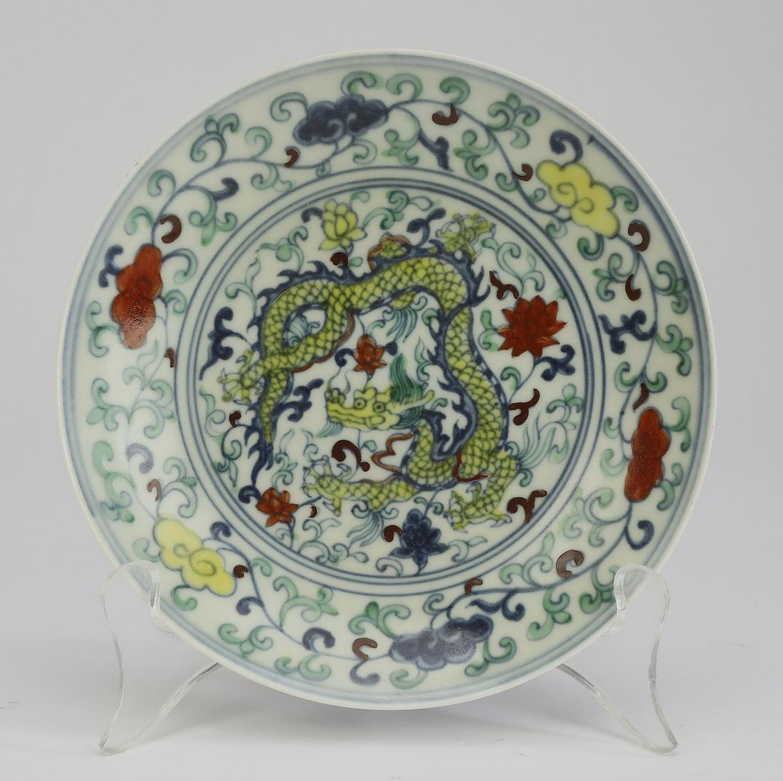 Chinese Ming style doucai dragon plate: Chinese Ming style doucai dragon plate, the interior centering a five clawed yellow writhing dragon amidst lotus scrollwork framed by multi-color lingzhi and tendrils, the exterior decorated with gree