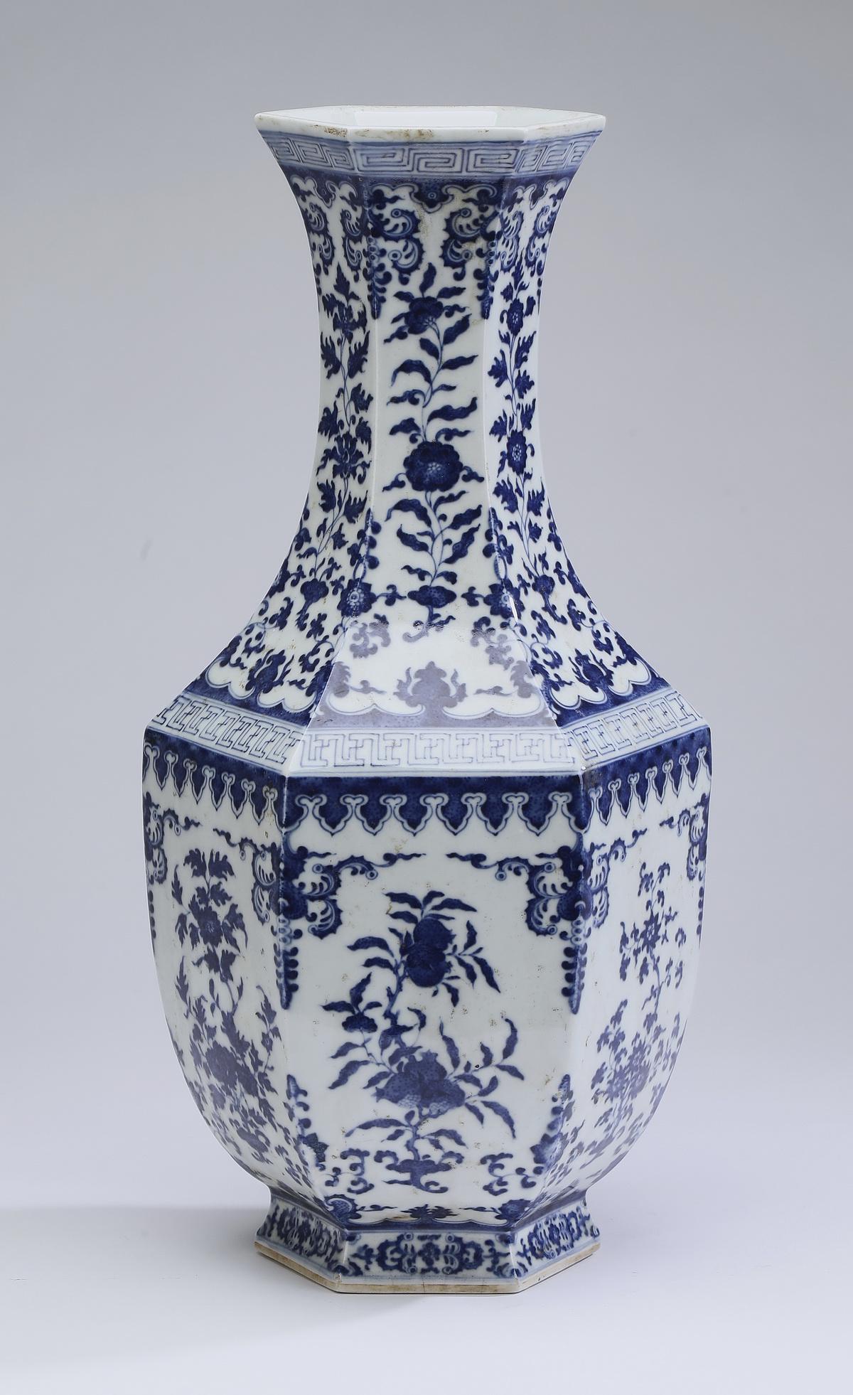 Chinese paneled vase with 'Three Plenties' motif: Chinese blue and white paneled bottle vase, having a trumpet neck with leiwen bands at the neck and shoulder, with lotus scrollwork between, the body decorated with pomegranates, peaches, and Buddha's