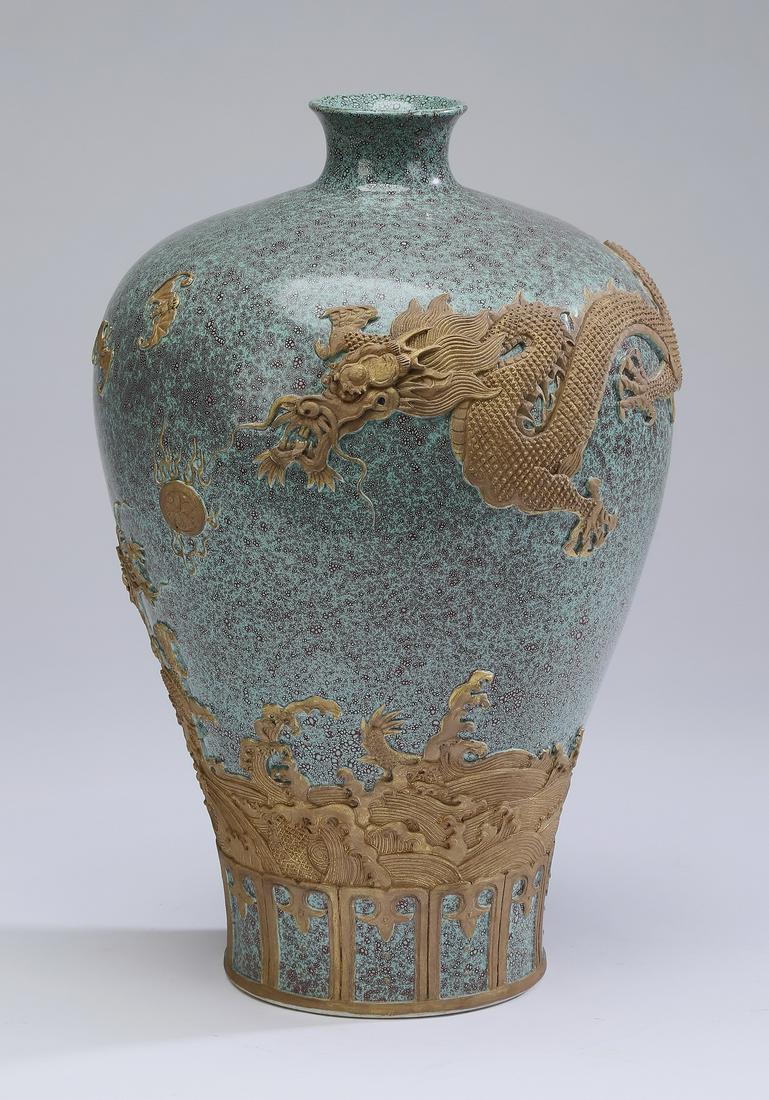 Chinese robin's egg vase with dragon motif: Chinese robin's egg glaze meiping vase, the shouldered form having relief carved yixing clay decoration depicting a pair of writhing five clawed dragons contesting a pearl of wisdom, while bats fly ab
