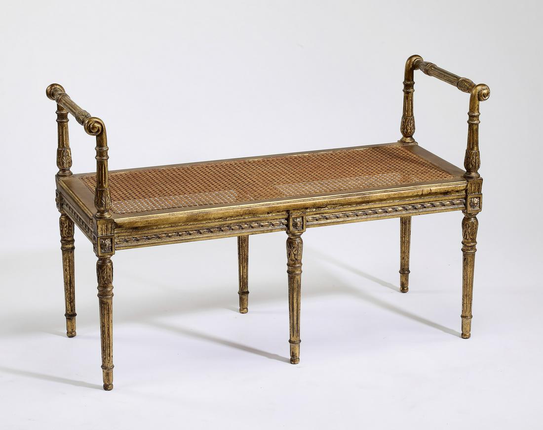 Louis XVI style caned and gilt-decorated bench, 40"w: Louis XVI style gilt-decorated bench, having carved armrests flanking the caned seat rising on carved and fluted legs terminating in toupie feet, 26"h x 40"w x 16.5"d.