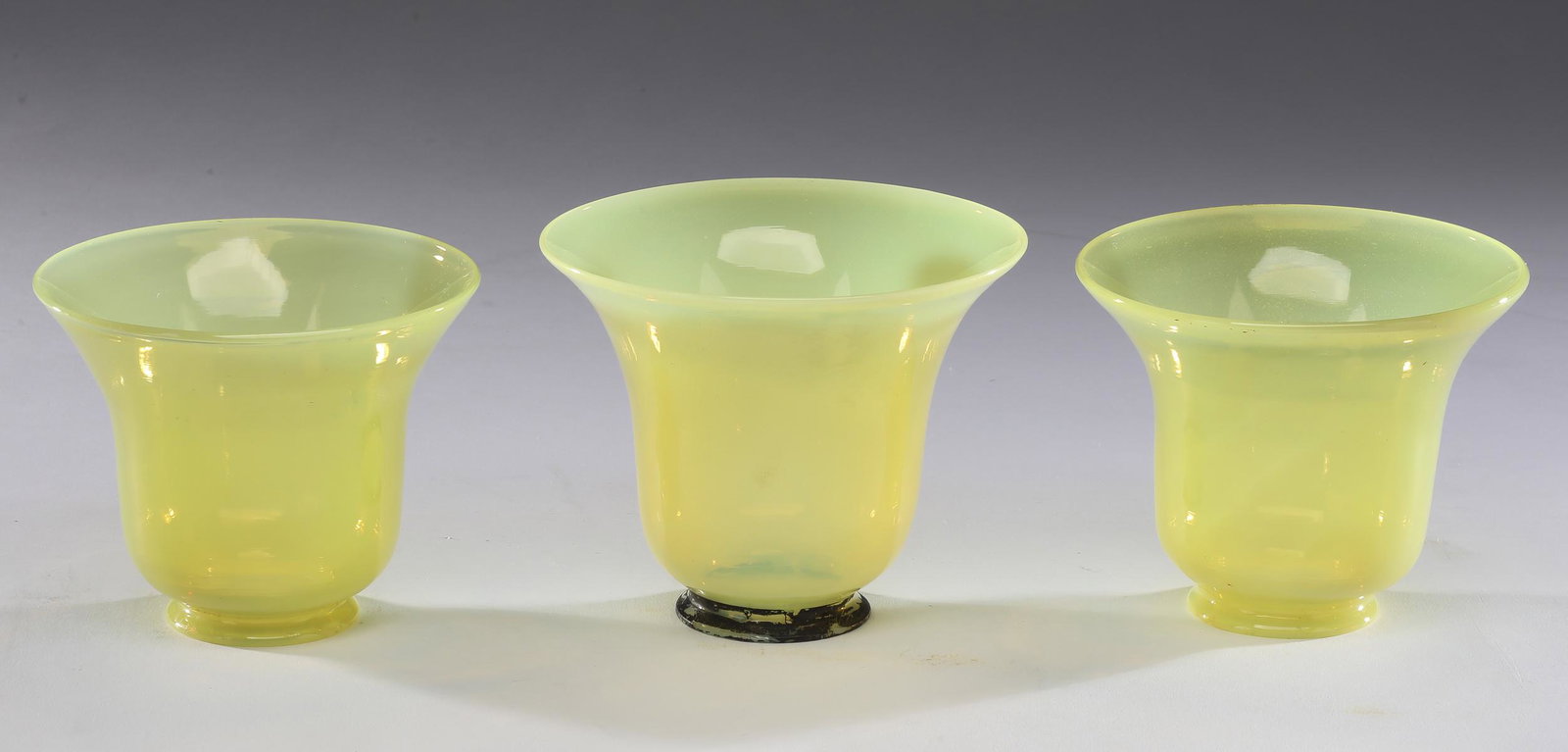 (3) Lemon opalescent glass tulip shades, 4.25"h: Set of three lemon opalescent glass tulip shades, of bell form with flared rims, 4.25"h x 4.75"dia; fitter 2.2"dia.
