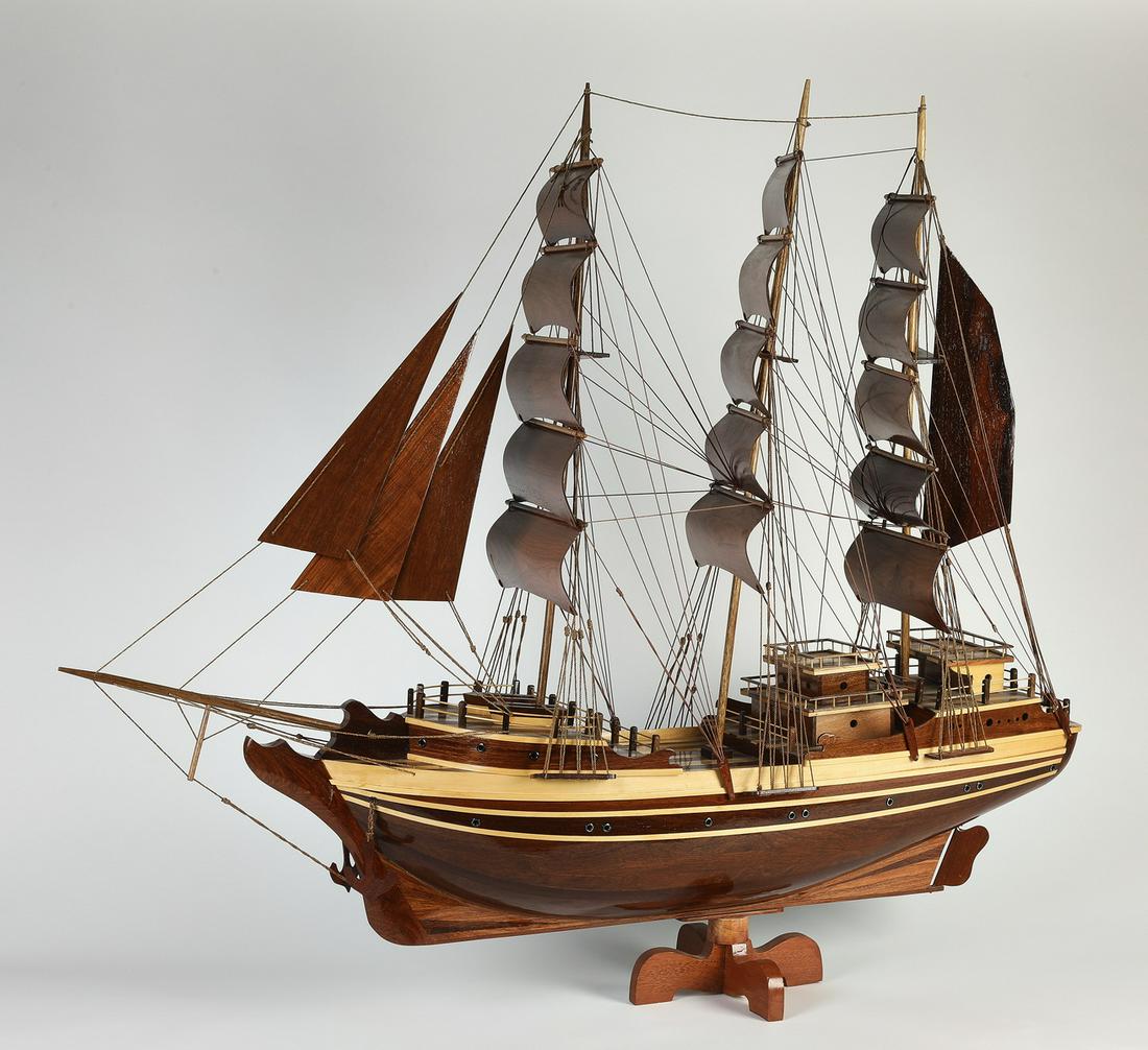 Tabletop all wood walnut and pine schooner model 49"l: Walnut and pine schooner model, 20th century, having tiered decks, masts, and intricate rope systems, rising on a spinning pedestal base, 41"h x 48.5"l x 11.5"w.