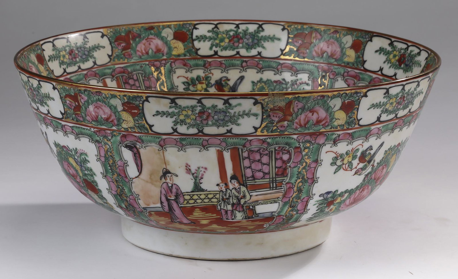 Chinese Rose Medallion center bowl, 14"w: Chinese Rose Medallion center bowl, the interior and exterior hand painted with alternating reserves depicting court scenes and floral sprays, having a gilt rim and ending in a recessed circular foot,