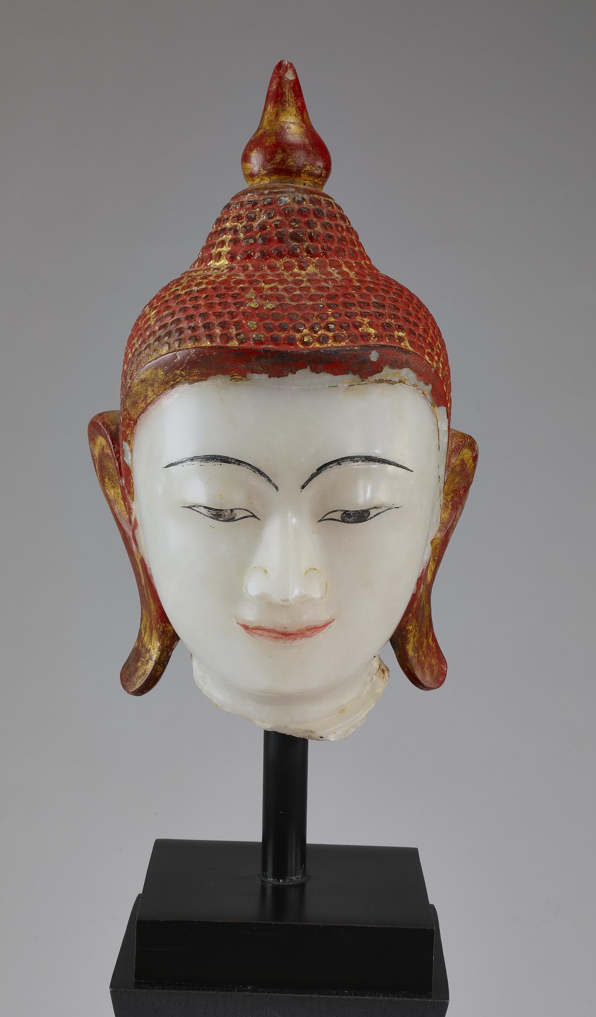 Contemporary alabaster bust of the Buddha on stand: Contemporary alabaster bust of the Buddha shakyamuni in the 18th century Burmese shan style, the face carved with a meditative expression, having arched eyebrows, an aquiline nose, and smiling lips, f