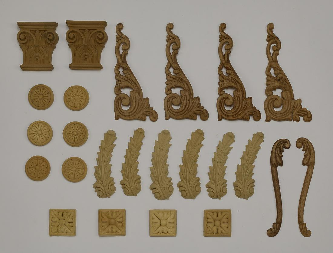 (24) Continental decorative appliques: Group of (24) Continental decorative appliques, including (2) capital appliques measuring 3"h x 2.5"w"d, (4) acanthus appliques measuring 6.5"h x 2.75"d, (6) circular appliques with foliate decoration
