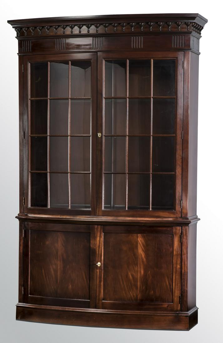 Hickory Chair demi-lune vitrine or bookcase, 94"h: Regency style demi-lune vitrine or bookcase by Hickory Chair, executed in mahogany, having a molded cornice above a band of carved spindles and a fluted band, surmounting two curved glass cabinet door
