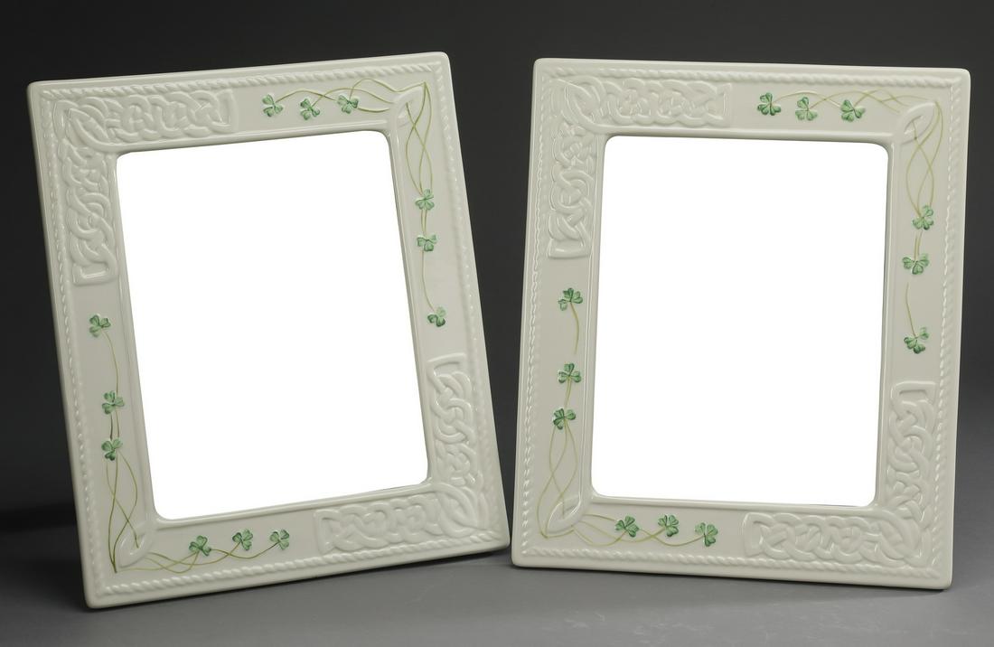 (2) Belleek porcelain 'Tara' photo frames: Pair of Belleek porcelain 8" x 10" photo frames in the 'Tara' pattern, each having molded Celtic knot motifs accented with hand painted shamrocks, 12.5"h x 11"w.