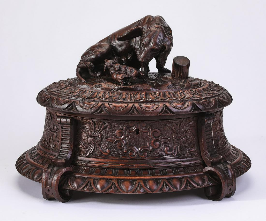 19th c. Black Forest oak jewelry box w/ dog and pups: Black Forest carved oak jewelry casket, late 19th century, having a figural finial depicting a hunting dog and her pups, over an oval box with a hinged lid, opening to a blue velvet lined interior, th