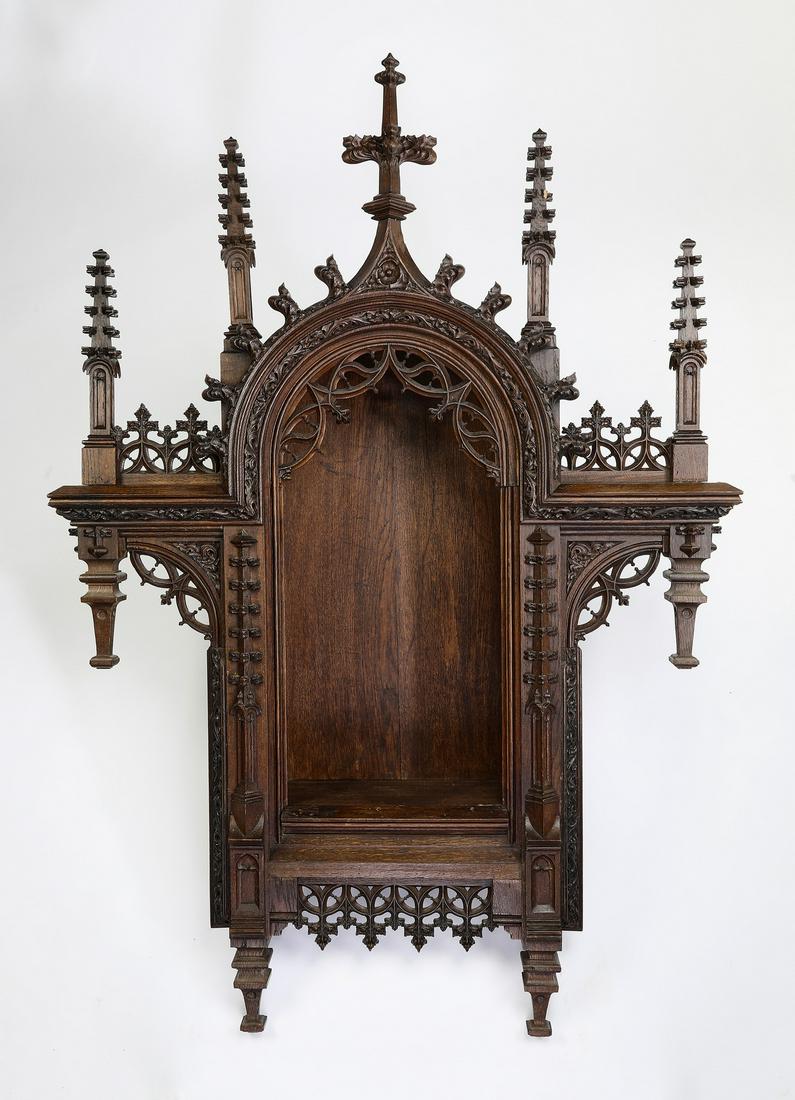 19th c. Gothic Revival carved oak hanging niche, 68"h: Gothic Revival carved oak hanging niche, 19th century, having a series of carved spire finials rising on the arched niche, with naturalistic relief-carving and pierce-carved borders centering the open