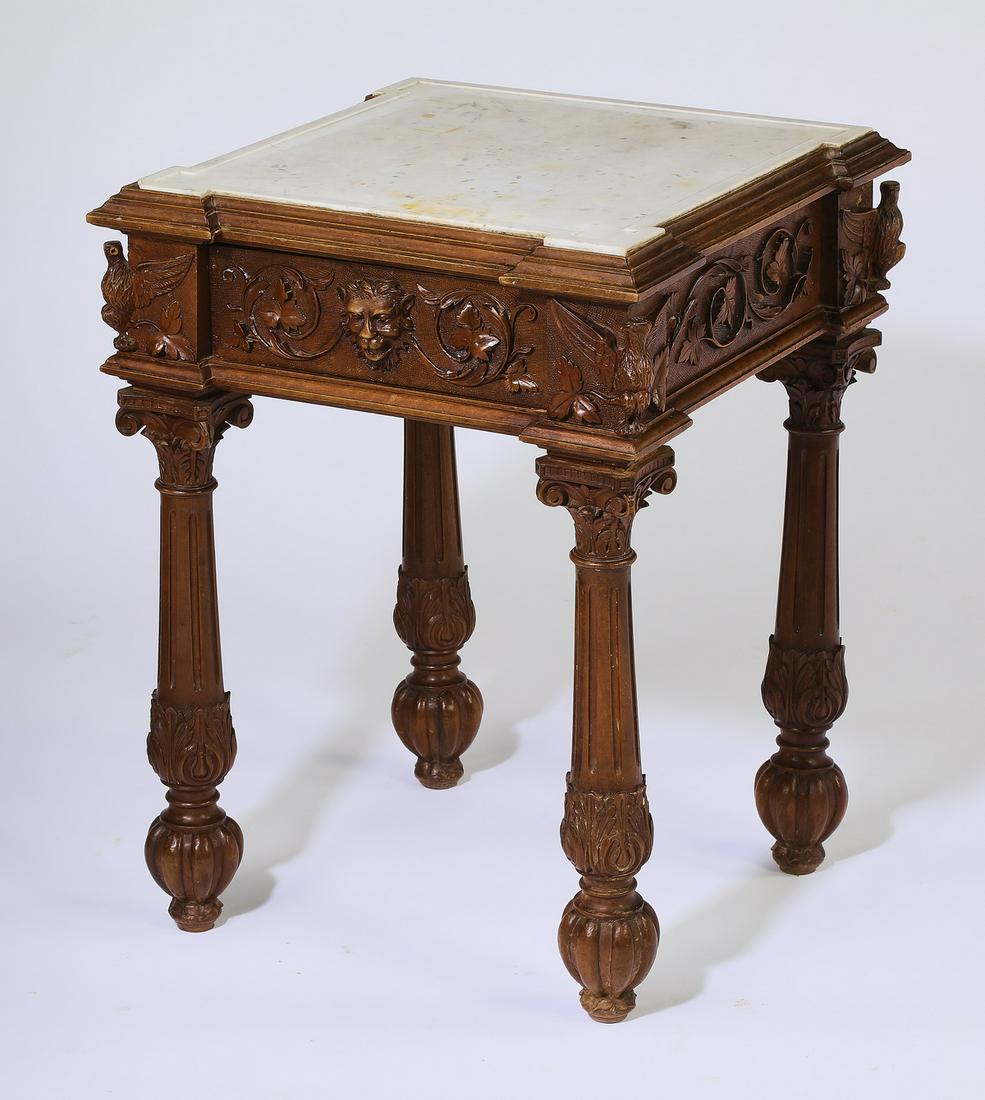 Victorian carved walnut marble top side table: Victorian walnut and marble side table, having a shaped white marble top surmounting a wide apron carved with foliate scrollwork, and having a single frieze drawer with a carved lion's head pull, the