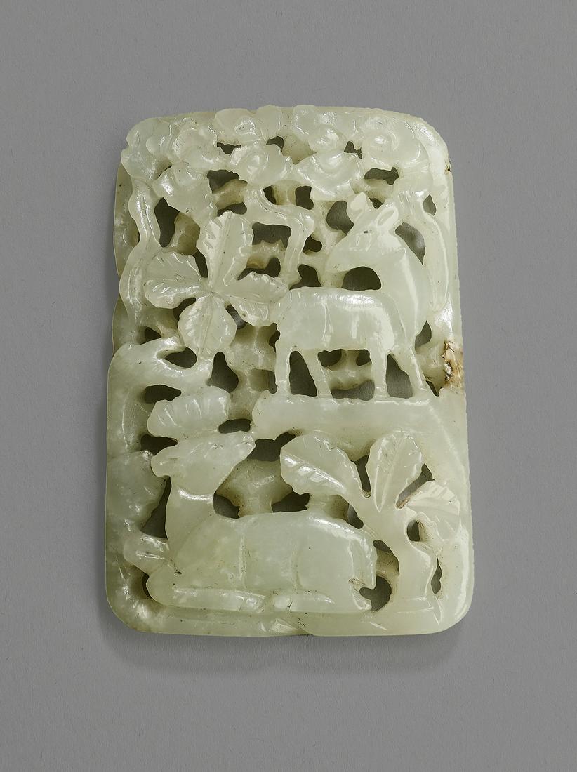 Chinese celadon jade pendant w/ pair of deer, 2.5"h: Chinese celadon jade pierce carved pendant, of rectangular form, depicting a pair of deer amidst foliage, one standing and one recumbent, 2.5"h x 1.75"w x .25"d.