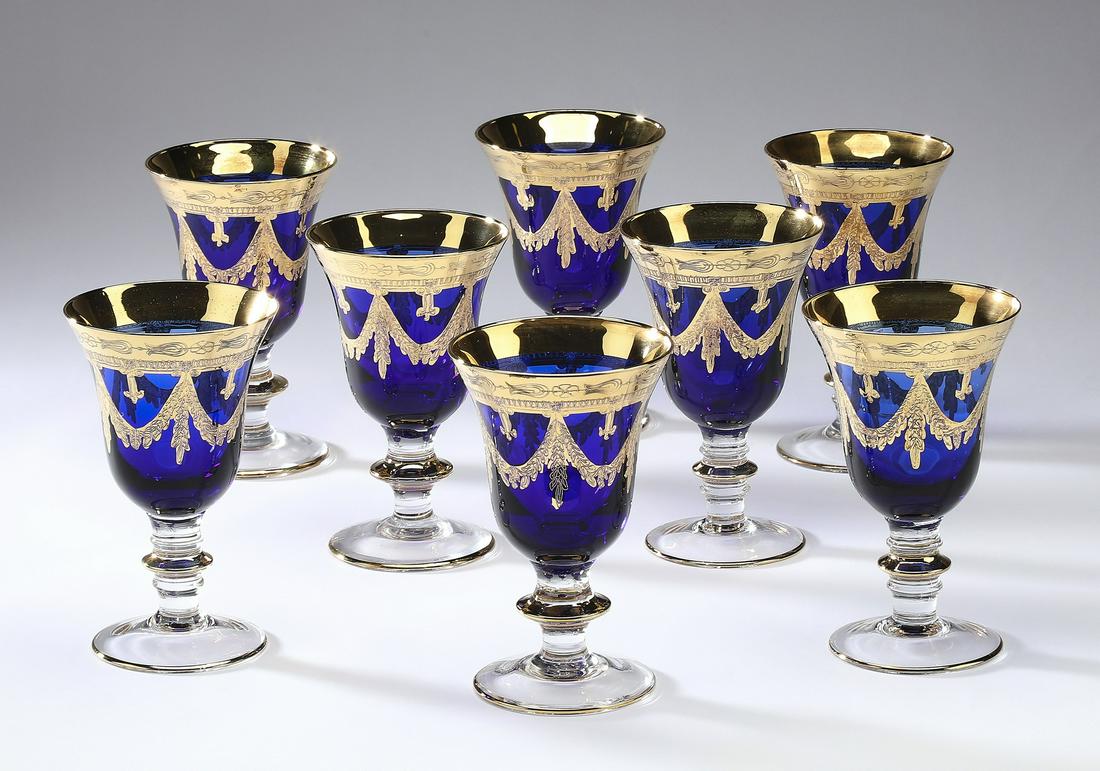 (8) Arte Italica 'Medici' cobalt blue wine glasses: (8) Arte Italica 'Medici' cobalt blue crystal wine glasses, each having a gilt band and garland swags rising on a knopped stem, 6.5"h x 4"dia.