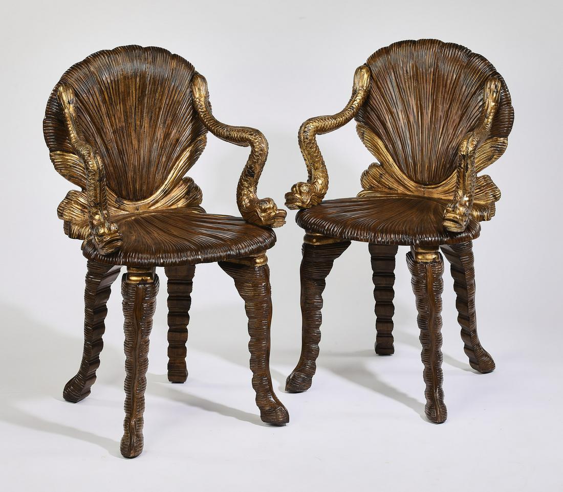 (2) Venetian grotto style carved armchairs: Pair of Venetian grotto style armchairs, executed in parcel gilt walnut, each having a shell shaped back and a seat with curving classical gilt dolphin arms, the whole rising on hairy carved cabriole 