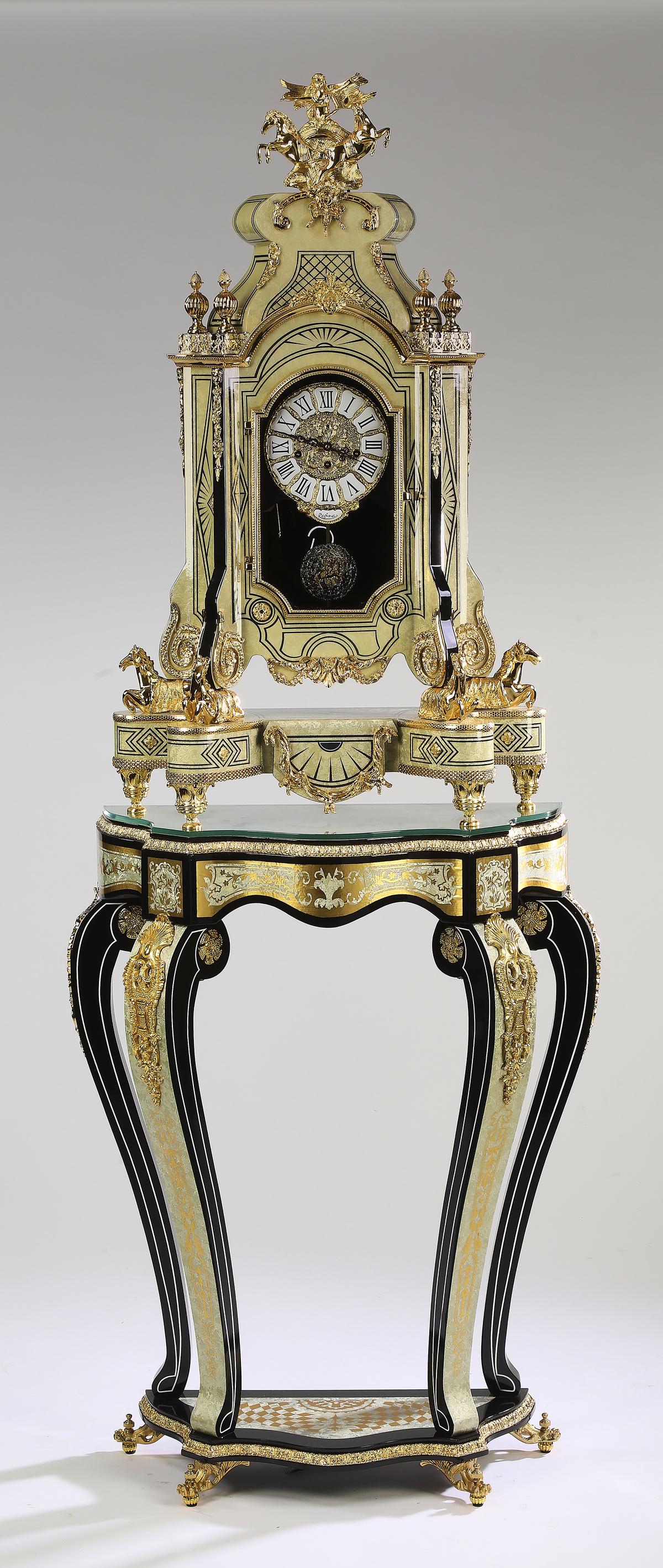 Louis XIV style marquetry and gilt clock on stand: Louis XIV style marquetry and gilt metal clock on stand, by Franz Hermle, after a design by Francois Lancelot circa 1710, having a gilt metal finial depicting a winged victory driving a two horse char