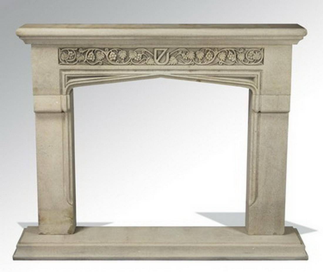 Gothic Revival style carved limestone mantel: Gothic Revival style carved limestone fireplace surround, having a rectangular mantel with a molded edge above bas relief frieze centering a stylized shield flanked by grapevines and tendrils, rising 