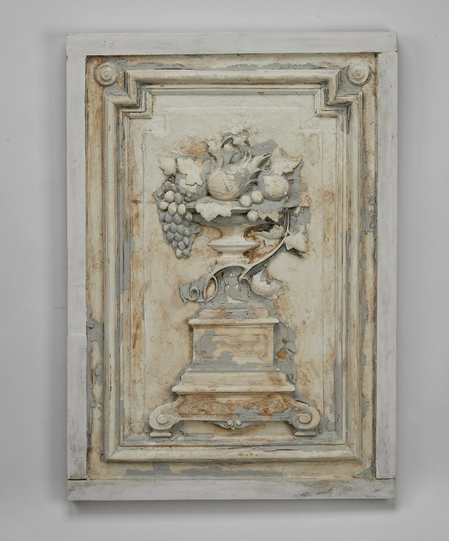 Late 19th c. cast plaster architectural panel, 32"h: Cast plaster architectural panel, late 19th century, having a molded border centering an urn with an elaborate fruit arrangement, with sculptural layers of historic paint-decoration, 32.5"h x 23"w x 2