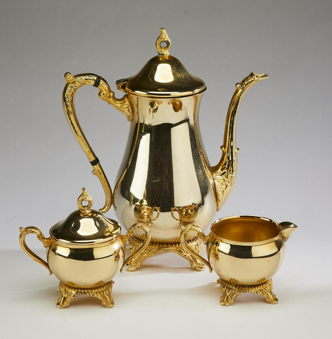 (3 pcs) Coffee service in the Rococo taste: Three piece gilt metal coffee service in the Rococo taste, comprising: (1) baluster form pot 11"h, (1) covered sugar 5"h, and (1) creamer 3"h.