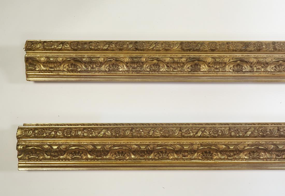 (2) Italian carved and gilt decorative moldings, 118": Pair of Italian carved and gilt decorative moldings, having floral, scallop, and ribbon borders, each measuring 5"h x 118.5"l x 2.5"d.