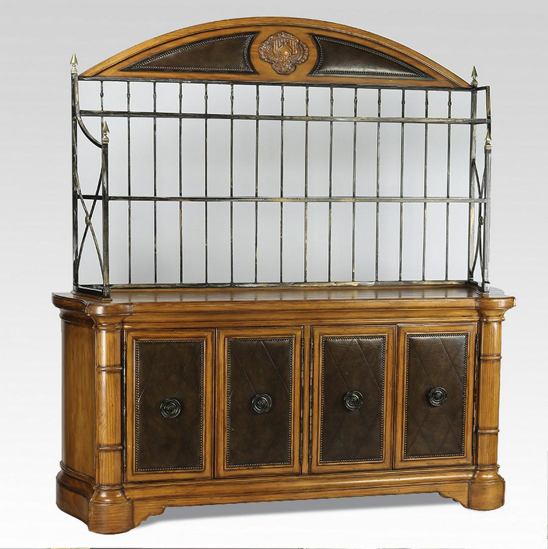 Ferguson Copeland buffet with leather accent panels: Ferguson Copeland buffet, having a demilune crest with a central scallop cartouche, flanked by two inlaid leather panels accented with nailhead trim, surmounting an aged metal and glass two-tier displ